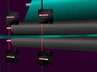 Mikrotrak Lasers set up to measure thickness of extruded sheet metal