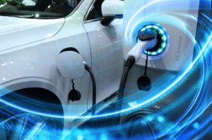 EV Car or Electric vehicle at charging station with the power cable supply plugged in on blurred nature with blue energy power effect. Eco-friendly sustainable energy concept.